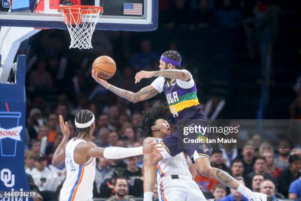 Brandon Ingram of the New Orleans Pelicans collides with Jaylin Williams of the Oklahoma City Thunder while driving towards the basket during the...