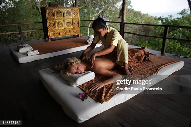 Woman gets a Thai massage in the open air massage sala at the Kamalaya Wellness Sanctuary June 18, 2012 . Thailand's official tourism body, the...