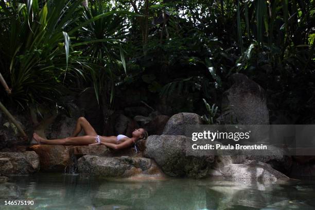 Woman rests along the rocks at the edge of the swimming pool at Kamalaya Wellness Sanctuary June 18, 2012 . Thailand's official tourism body, the...