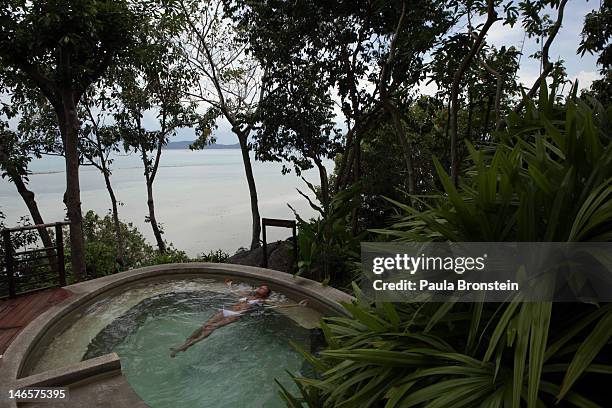 Woman floats in a splash pool at the Kamalaya Wellness Sanctuary June 18, 2012 . Thailand's official tourism body, the Tourism Authority of Thailand...