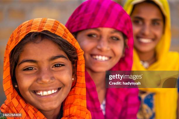 happy indian girls in desert village, india - hindoeïsme stockfoto's en -beelden