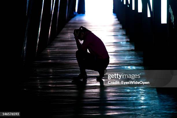 Symbol of a person, woman in a depressive pychological crisis after a break-up, divorce in a tunnel on Feb 21, 2012 in Denia, Spain.