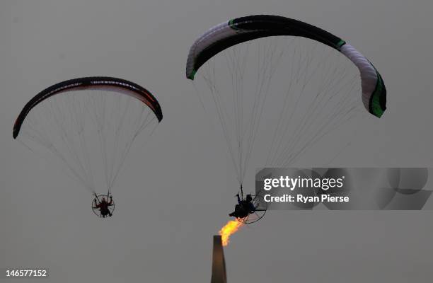 Competitors fly past the Games Cauldron during the Powered Paragliding Open Individual Economy Final on Day 4 of the 3rd Asian Beach Games Haiyang...