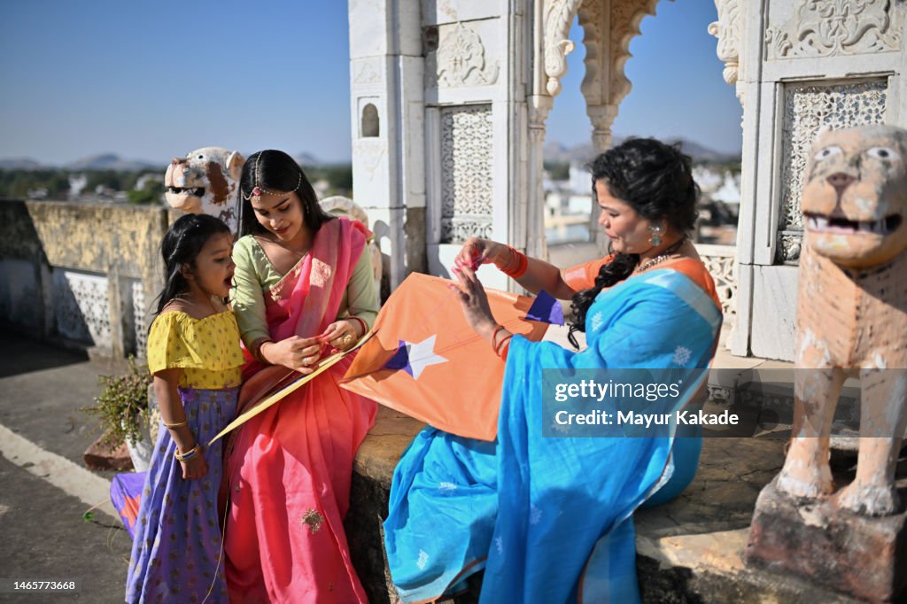 Group of women and girls preparing their kites while celebrating Makar Sankranti, an Indian Hindu festival