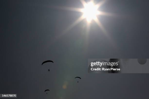 Competitors fly during the Powered Paragliding Open Individual Economy Final on Day 4 of the 3rd Asian Beach Games Haiyang 2012 on June 20, 2012 in...