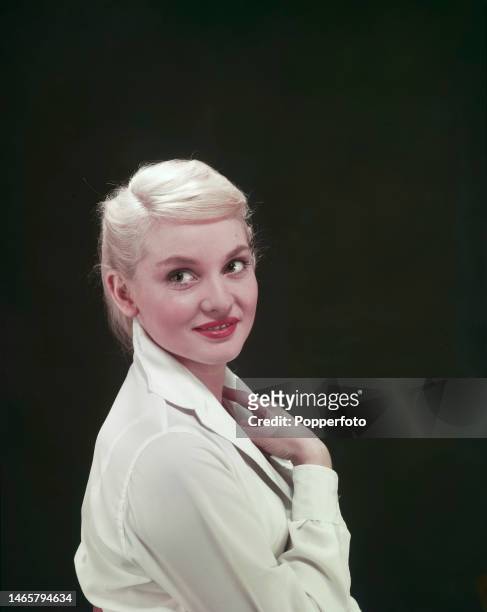 Posed studio portrait of Australian actress Diane Cilento wearing a white blouse, London, 1954.