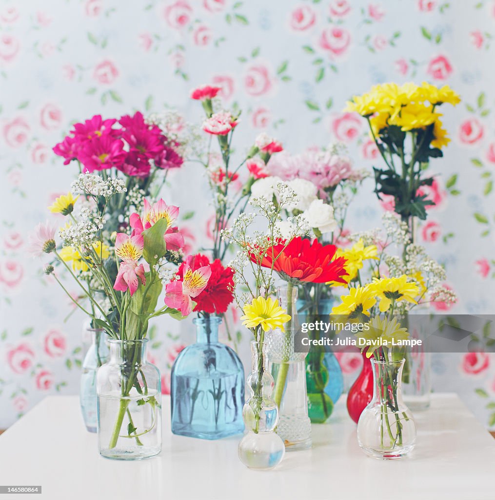 Variety of flowers in bottles