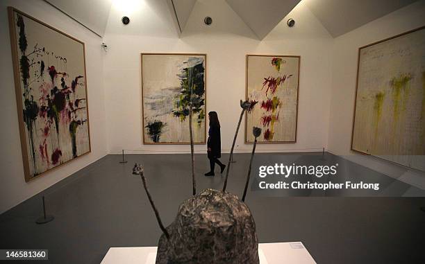 Staff member views Quattro Stagioni, by Cy Twombly during a press preview for an exhbition of the works of artists Claude Monet, J M W Turner and Cy...