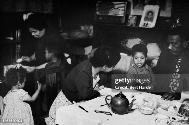 Mrs Johnson , her daughters, a son-in-law and some of her grandchildren at home in their dining room, 1949. Original Publication: Picture Post - 4825...