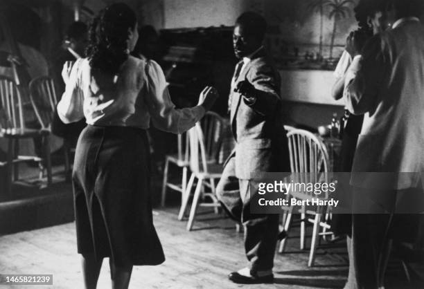 Couples dancing in a bar to a live band, 1949. Original Publication: Picture Post - 4825 - Is There A British Colour Bar? - pub. 2nd July 1949