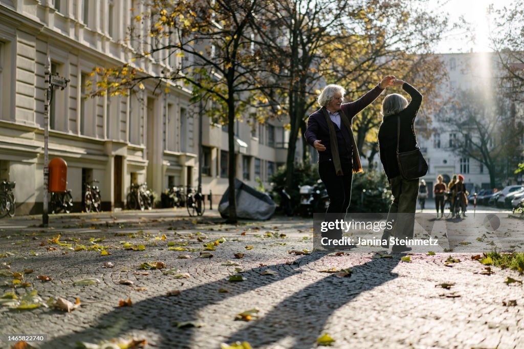 Senior Couple dancing in city square
