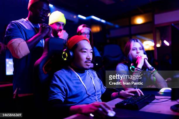 chinese gamer playing esports video game for his team in gaming club. - e sport stock pictures, royalty-free photos & images