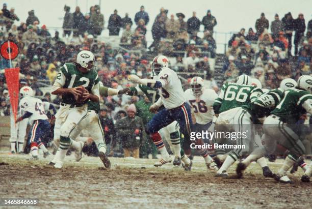 American football player Joe Namath of the New York Jets in action during a game against Buffallo Bills at Shea Stadium, New York, in the snow, on...