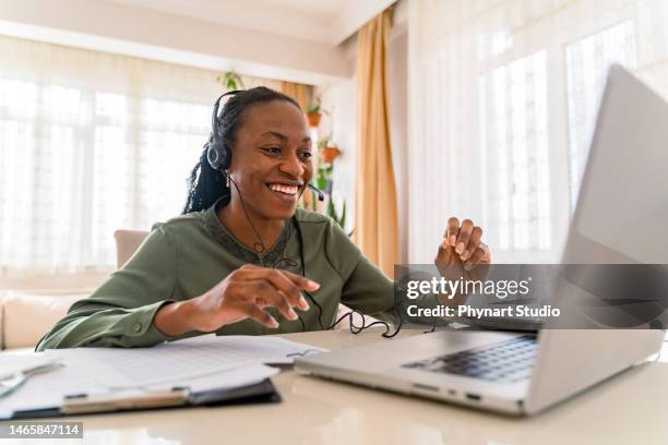 black  businesswoman wearing headphones using laptop, - big smile stock pictures, royalty-free photos & images