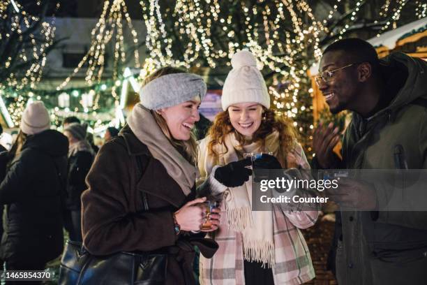 multi-racial group of friends at christmas market - shopping candid stock pictures, royalty-free photos & images