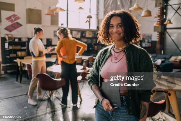 portrait of multiracial professional with colleagues in co-working space - colleagues stock pictures, royalty-free photos & images