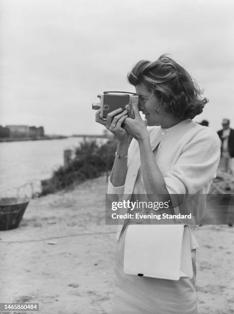 American socialite Patricia Kennedy Lawford using an cine camera on the set of 'The Longest Day' in Normandy, France, 6th September 1961. The film,...