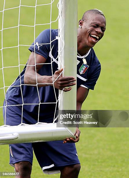 Mario Balotelli of Italy laughs during a training session ahead of their UEFA EURO 2012 quarter-final against England at Marshal Józef Pilsudski...