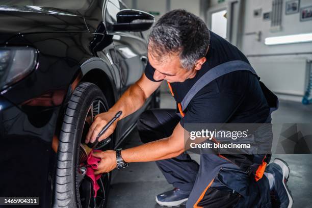 professional worker cleaning car rim - shiny car stock pictures, royalty-free photos & images