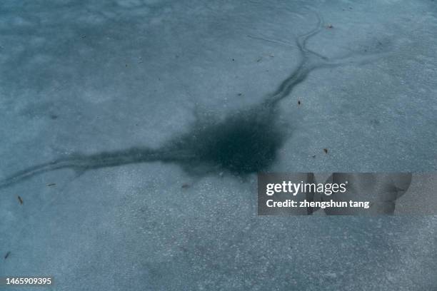 crack in the ice - ice crack stock-fotos und bilder