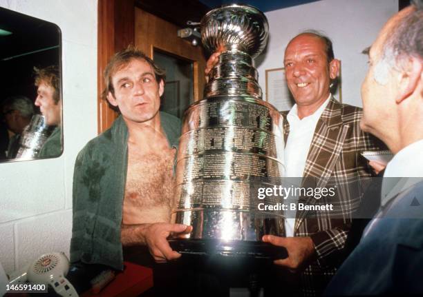 Guy Lafleur of the Montreal Canadiens holds the Stanley Cup in the locker room during one of Montreal's Championship seasons in the 1970's.