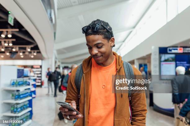 staying connected on his travels - only young men stock pictures, royalty-free photos & images