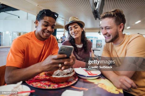 grabbing a quick bite to eat - restuarant stock pictures, royalty-free photos & images