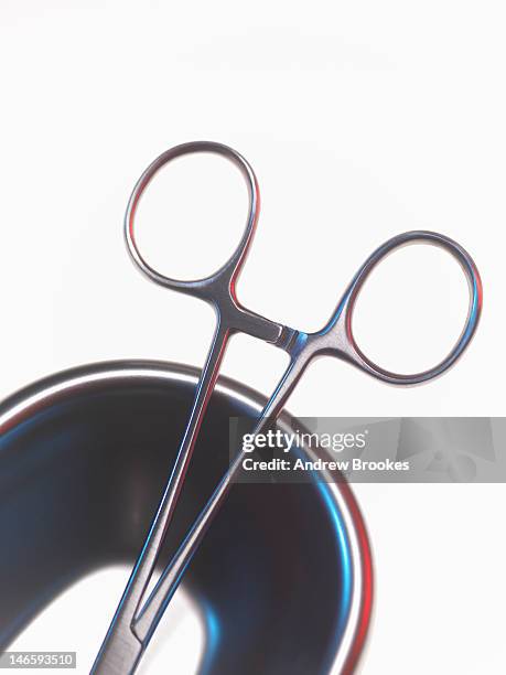 close up of scissor forceps in bowl - fórceps fotografías e imágenes de stock