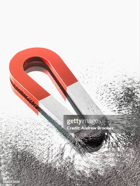 close up of magnet and iron filings - iron filings stock pictures, royalty-free photos & images