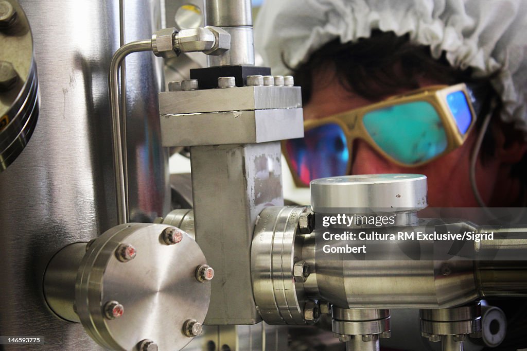 Scientist aligning lasers in lab