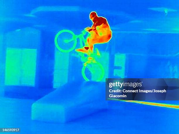 thermal image of bmx biker doing tricks - thermal image stock pictures, royalty-free photos & images