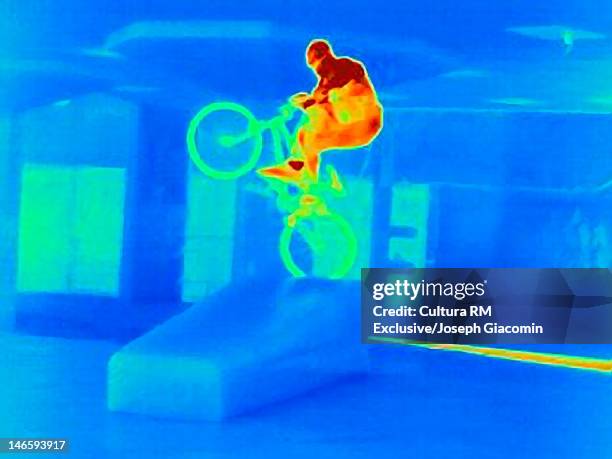 thermal image of bmx biker doing tricks - thermal imaging imagens e fotografias de stock