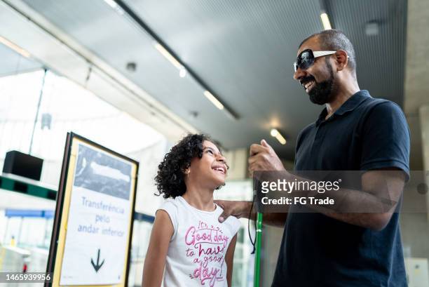 blind father and daughter talking at a subway station - blind girl stock pictures, royalty-free photos & images