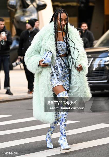 Cheyenne Maya Carty is seen wearing a faux fur green coat and Carolina Herrera top, skirt and boots with bag outside the Carolina Herrera show during...