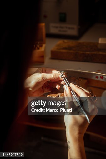 Woman jeweller looking gemstone