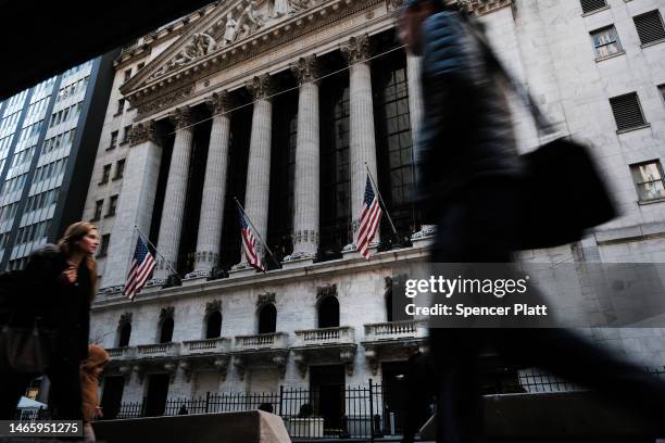 People walk by the New York Stock Exchange on February 14, 2023 in New York City. The Dow was down in morning trading following news that the January...