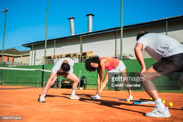 athletes doing stretching - atividade stock pictures, royalty-free photos & images