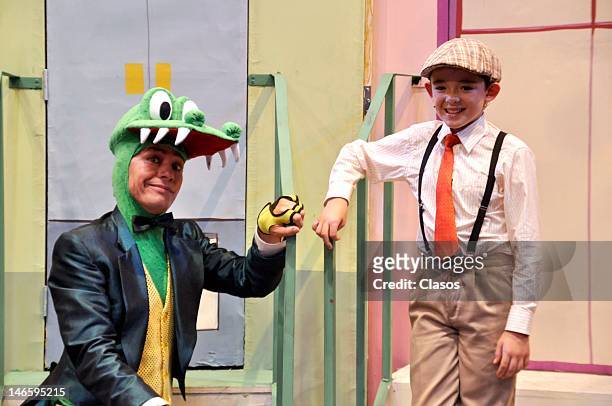 Two actors poses for the photo on stage during the presentation of Lylo the Cocodrille kids musical at the Pabellón de Alta de Tecnología on June 19,...