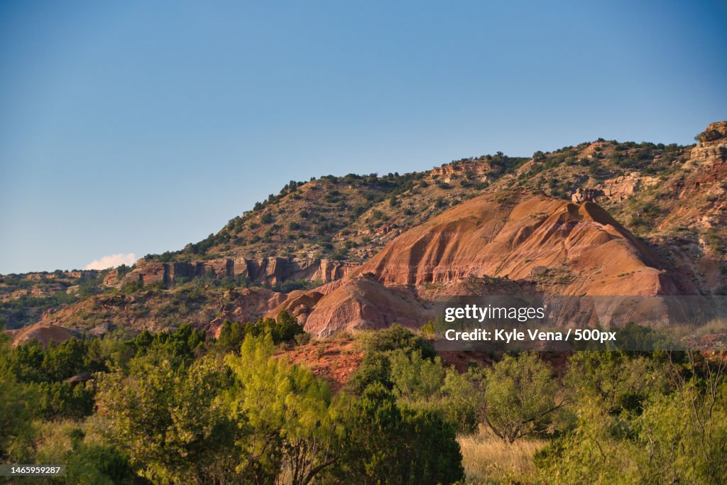 Scenic view of rocky mountains against clear blue sky