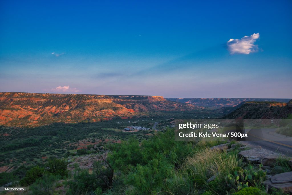 Scenic view of landscape against blue sky