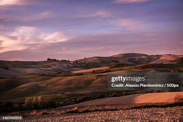 scenic view of landscape against sky during sunset,volterra,province of pisa,italy - volterra stock-fotos und bilder
