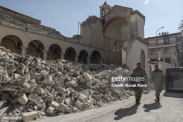 Soilders walk in front of of the damaged Roman Catholic Church of Annunciation on February 14, 2023 in Iskenderun, Turkey. A 7.8-magnitude earthquake...