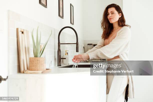 woman washing hands in the kitchen - washing hands close up stock pictures, royalty-free photos & images