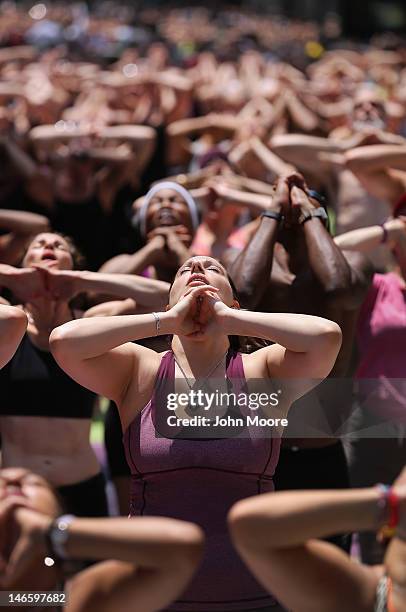People brave high temperatures while practicing bikram yoga as part of the annual Mind Over Madness event in Times Square on June 20, 2012 in New...