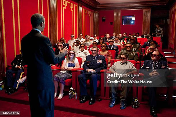 In this handout provided by the White House, U.S. President Barack Obama welcomes service members and their families to a screening of Men in Black 3...