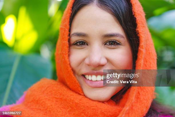 beauty portrait of hispanic woman with soft skin smiling on tropical background. - winter skin stock pictures, royalty-free photos & images