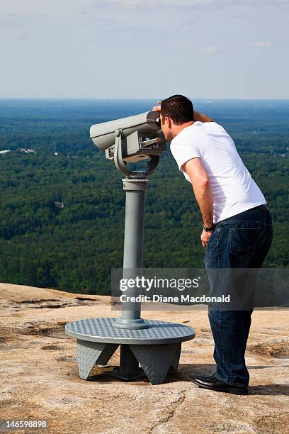 man and telescope on stone mountain, georgia - stone mountain stock pictures, royalty-free photos & images