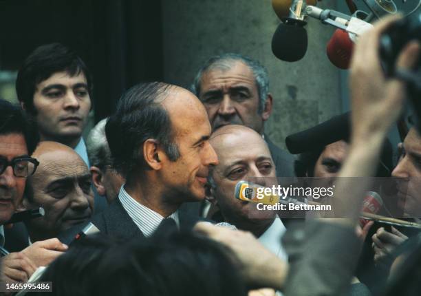 The newly-elected French President Valery Giscard d'Estaing is besieged by members of the press as he leaves Elysee Palace in Paris on May 20th, 1974.