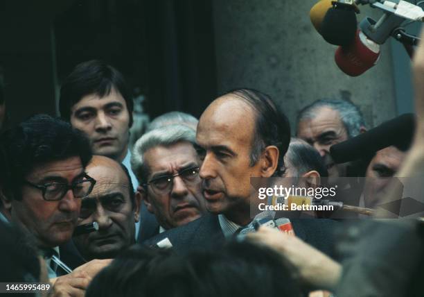 The newly-elected French President Valery Giscard d'Estaing is besieged by members of the press as he leaves Elysee Palace in Paris on May 20th, 1974.
