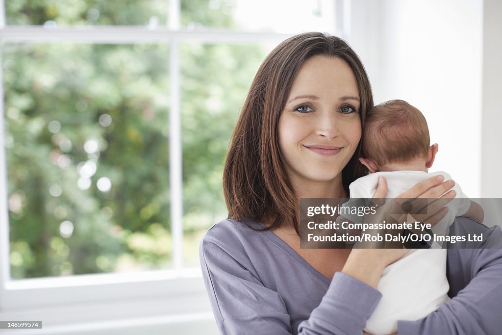 Mother holding baby (0-3 months)